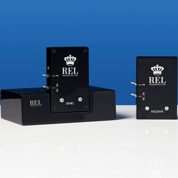 REL arrow wireless transmitter on a white surface with a blue background