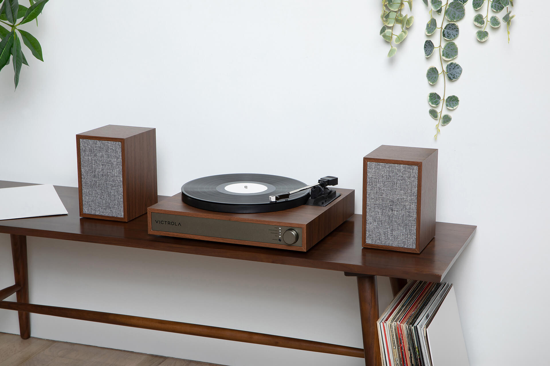 Victrola vts-1300 on a table against a white wall with plants.
