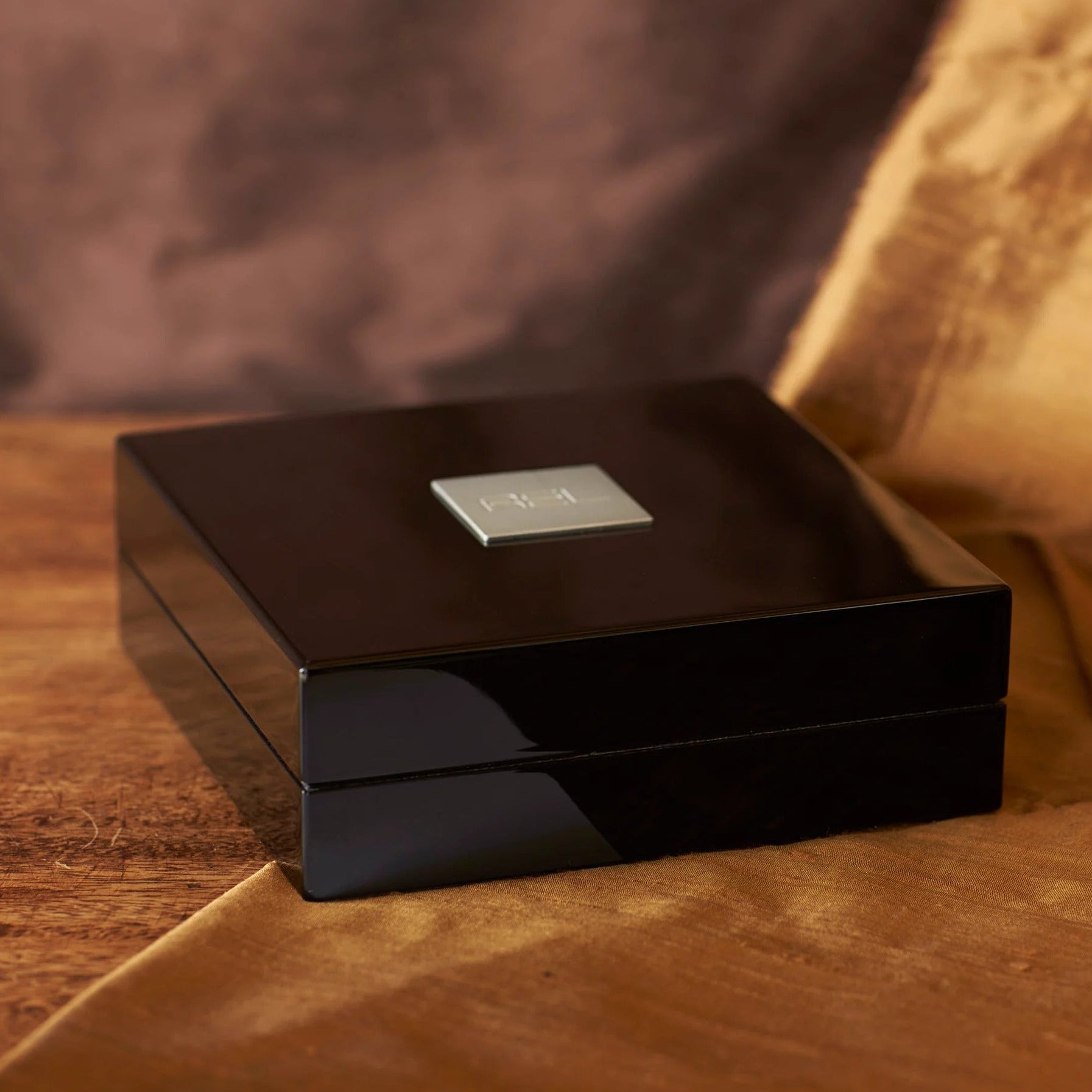 REL longbow wireless transmitter on a brown fabric background