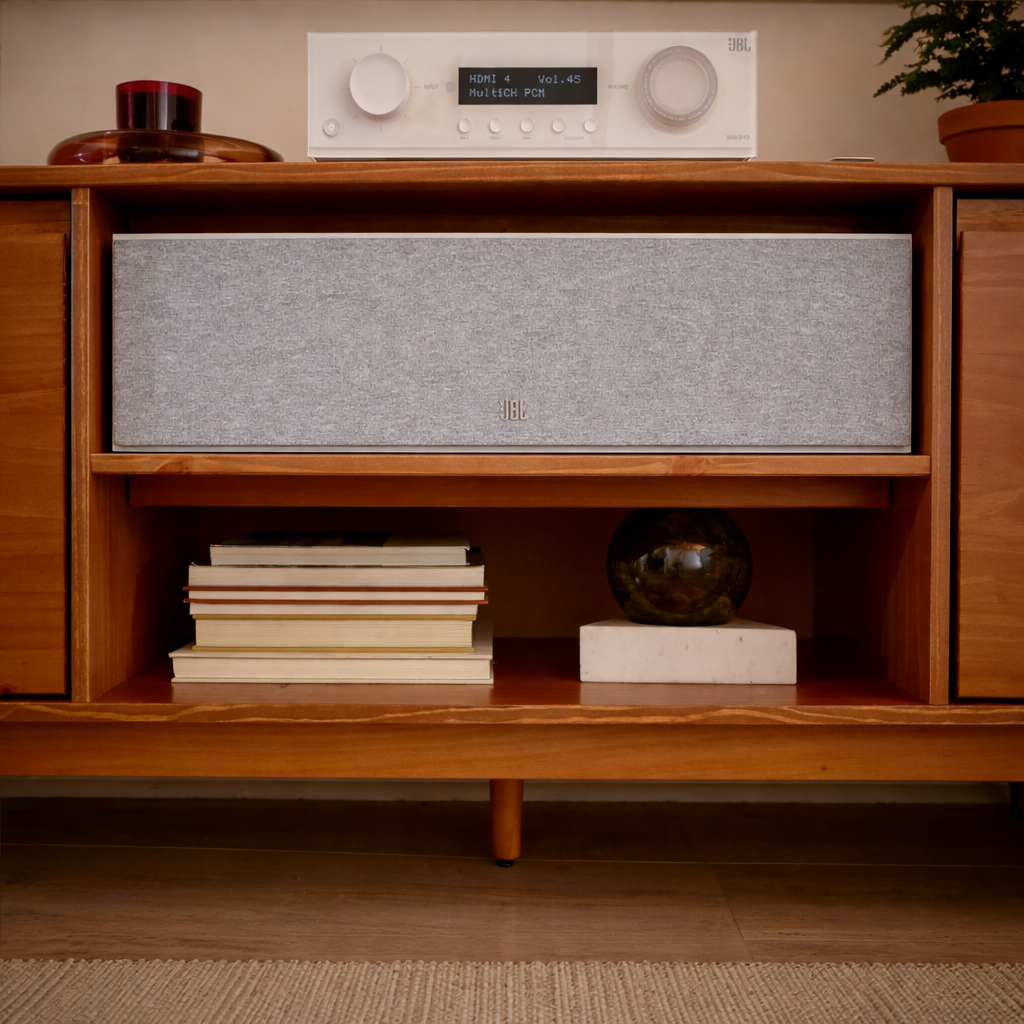 jbl Stage2 245c centre channel speaker and books in a table shelf.